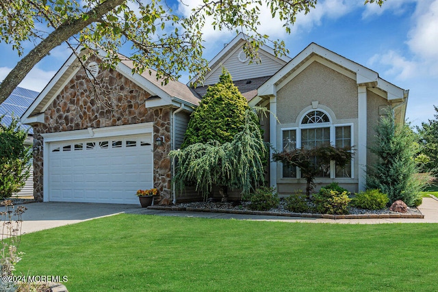 view of front of property featuring a garage and a front yard