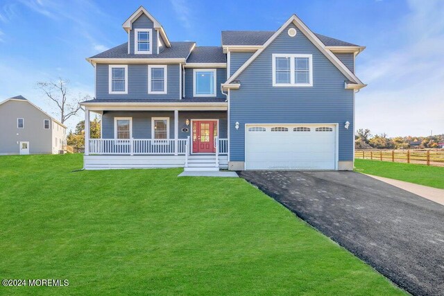 view of front of home featuring a front yard, a porch, and a garage