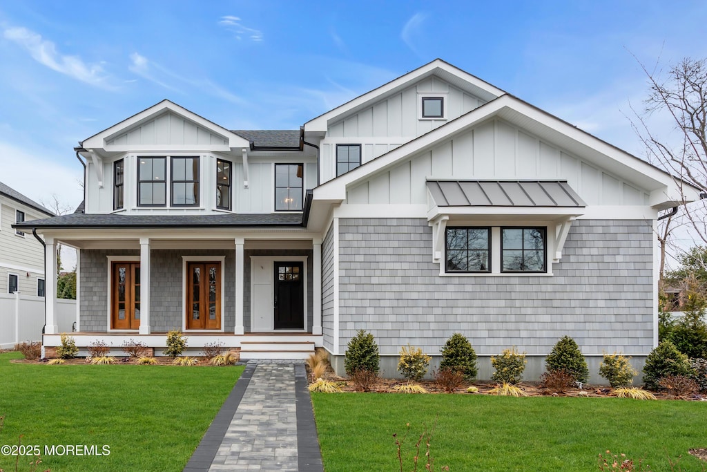 view of front of home with a front yard and a porch