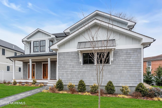 view of front of home featuring covered porch and a front lawn