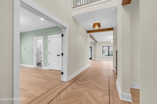 hall featuring parquet floors and beamed ceiling