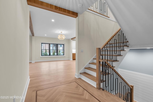 stairway featuring an inviting chandelier, parquet floors, and beam ceiling