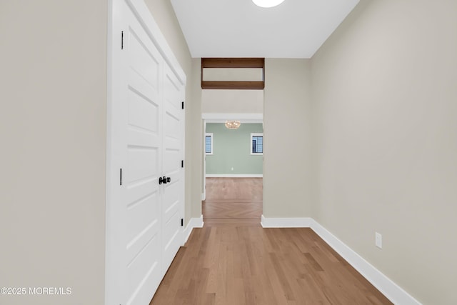 hallway with light hardwood / wood-style floors