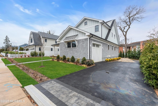 view of front of house with a garage and a front lawn