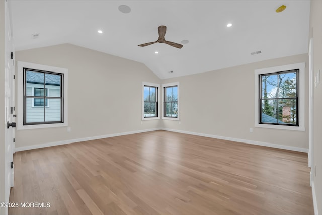 unfurnished room featuring ceiling fan, vaulted ceiling, and light hardwood / wood-style flooring