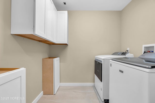 laundry room with washer and dryer and cabinets