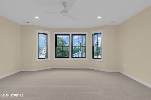 spare room featuring ceiling fan and carpet floors