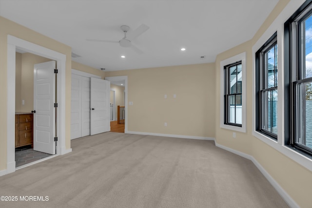 carpeted empty room featuring ceiling fan