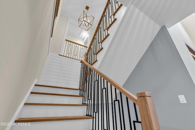 stairs with a chandelier