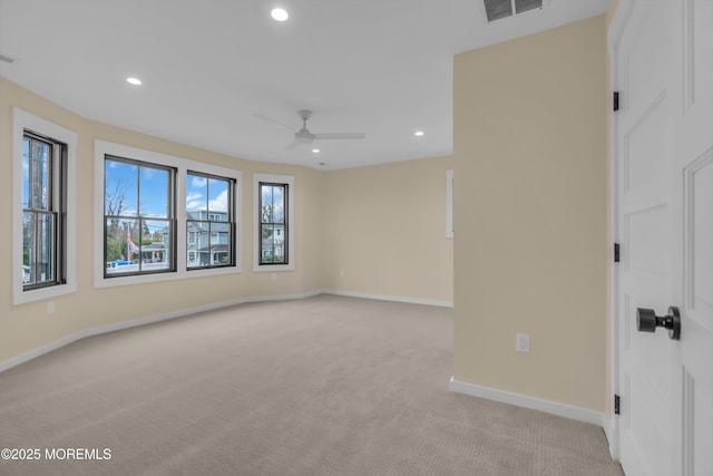 empty room featuring ceiling fan and light carpet