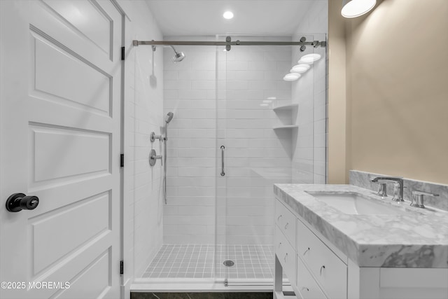 bathroom with an enclosed shower and vanity