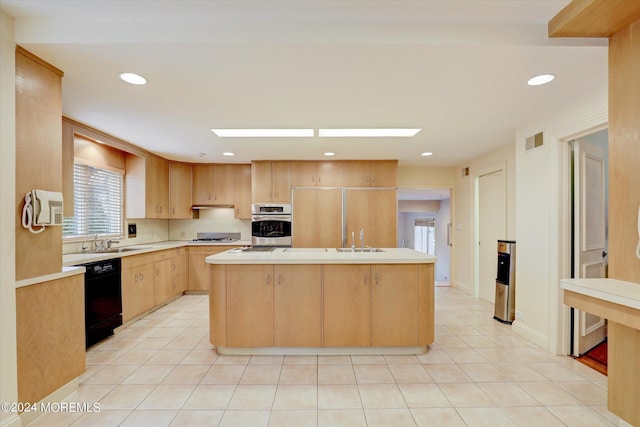 kitchen with visible vents, a kitchen island, appliances with stainless steel finishes, and light countertops