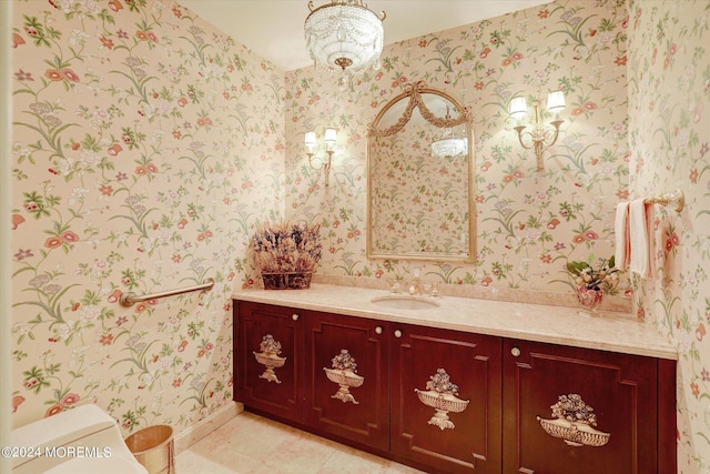 half bathroom with toilet, wallpapered walls, tile patterned flooring, and vanity