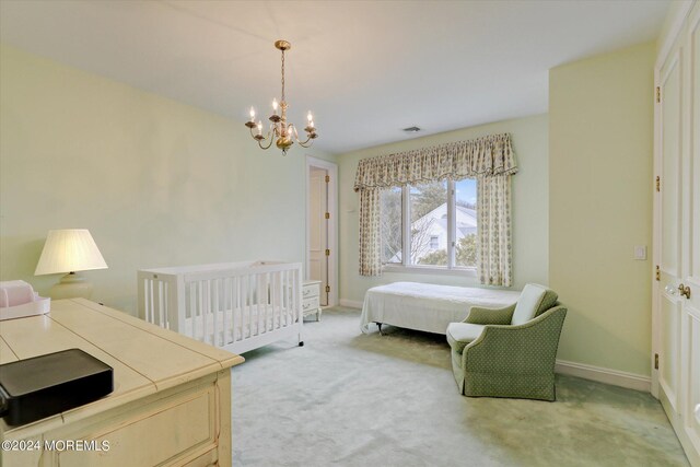 bedroom with baseboards, a chandelier, visible vents, and light colored carpet