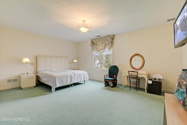 carpeted bedroom featuring baseboards and visible vents