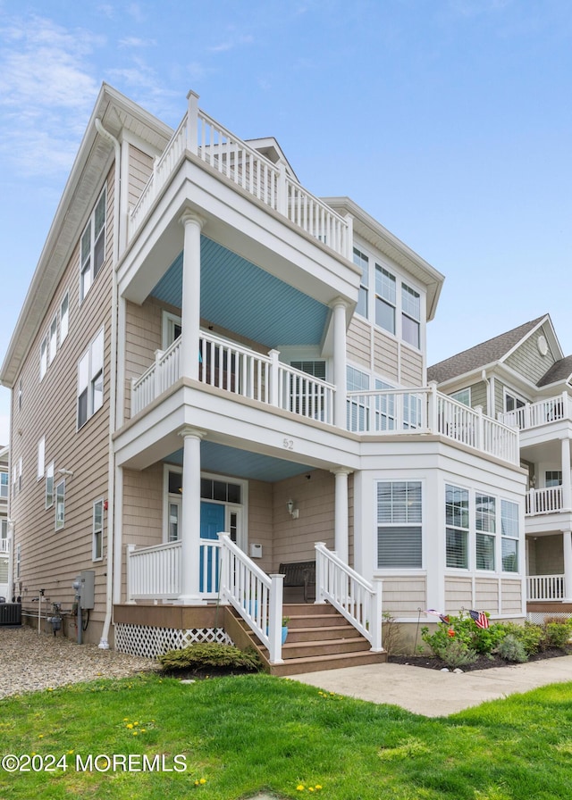 52 Seaview Ave, Long Branch, NJ 07740 - view of front of house with a balcony, a front yard, a porch, and cooling unit