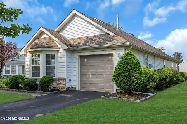 view of side of property with a yard and a garage