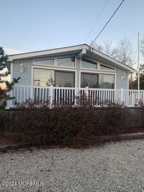 view of side of property with a porch