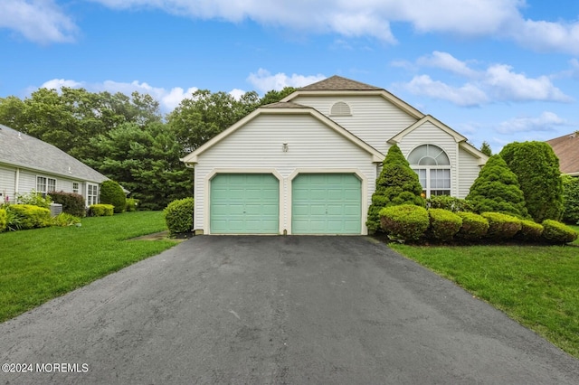 view of front of house featuring a garage and a front lawn