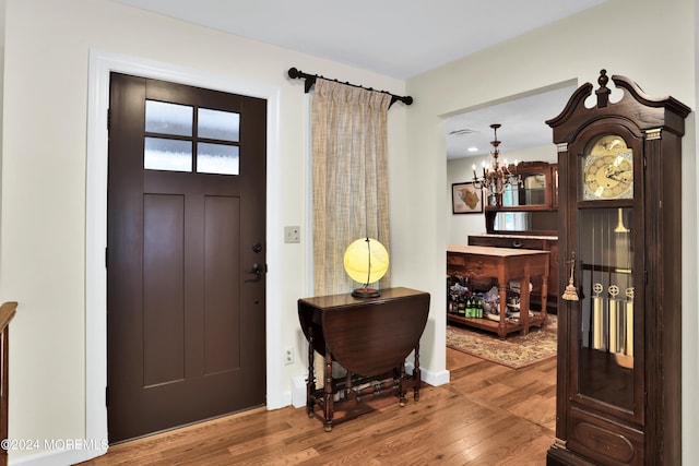 foyer featuring an inviting chandelier and wood-type flooring