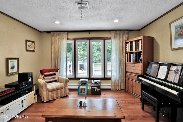 living area featuring crown molding, a textured ceiling, and hardwood / wood-style flooring