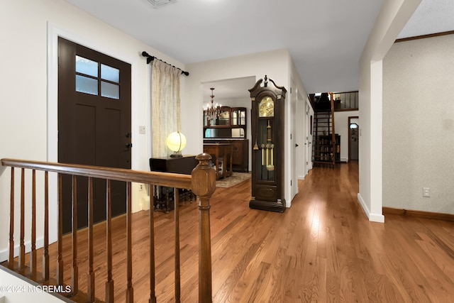 foyer entrance featuring a notable chandelier and hardwood / wood-style floors