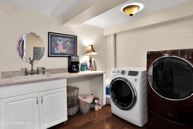 laundry room with cabinets, sink, dark wood-type flooring, and washing machine and dryer