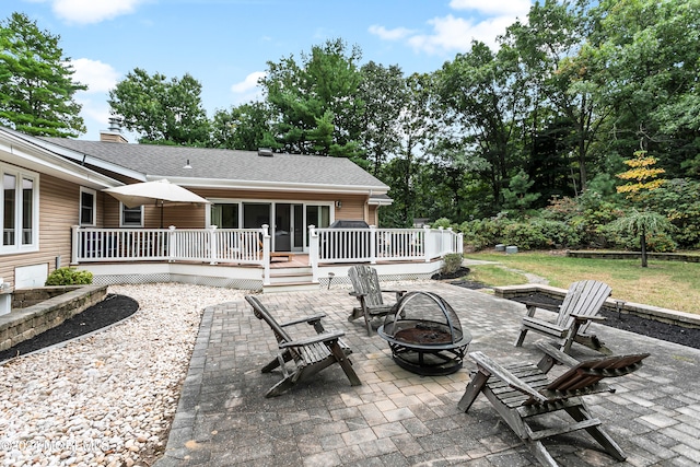 view of patio featuring a wooden deck and an outdoor fire pit