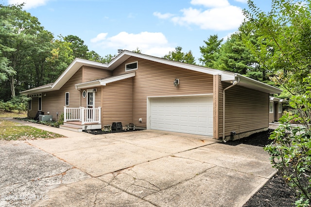 view of front of house featuring cooling unit and a garage