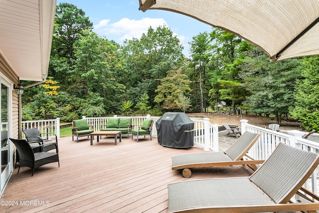 deck with an outdoor hangout area and a grill