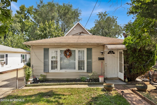 bungalow-style home with a front lawn