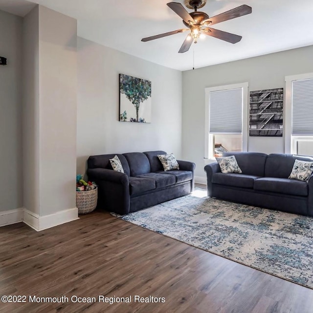 living room with ceiling fan and dark hardwood / wood-style floors