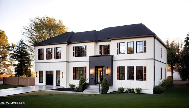 view of front of house featuring a front yard and fence