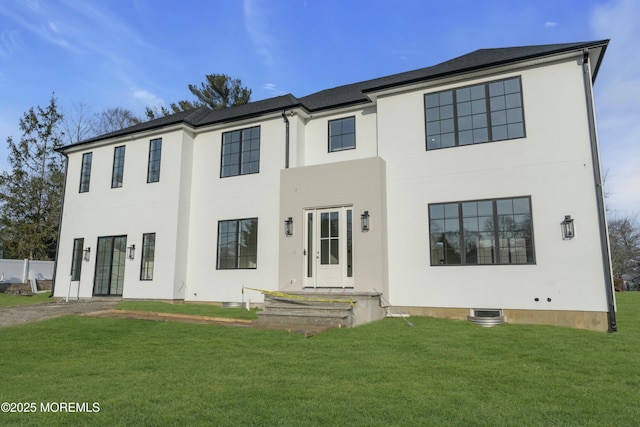 view of front of property with a front lawn and stucco siding