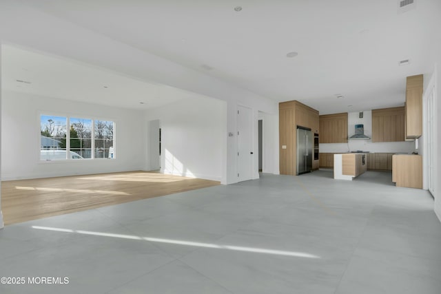 unfurnished living room featuring baseboards