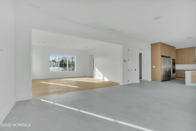 interior space featuring light tile patterned floors and baseboards