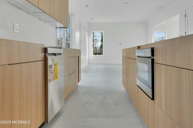 kitchen with light brown cabinetry, modern cabinets, and oven