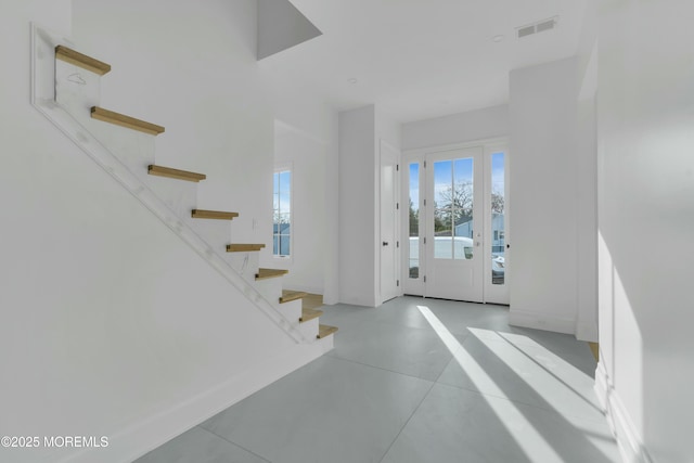 entryway featuring visible vents, baseboards, and stairs