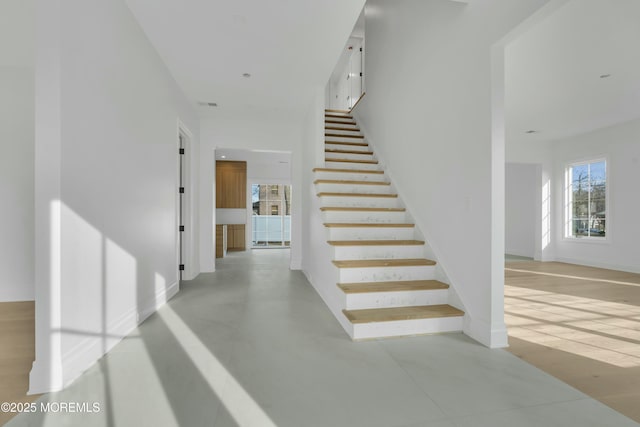 staircase featuring baseboards