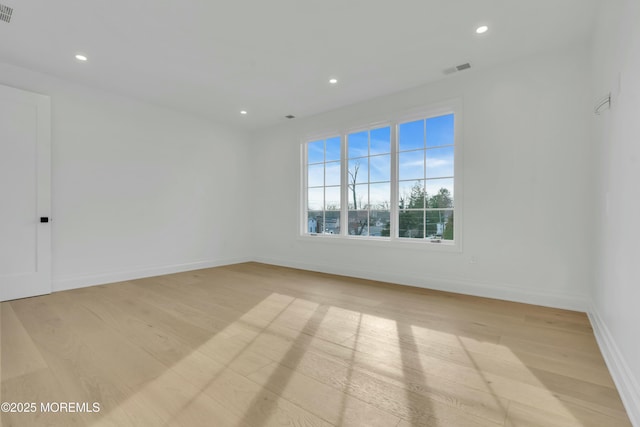 empty room featuring recessed lighting, visible vents, baseboards, and light wood-style floors