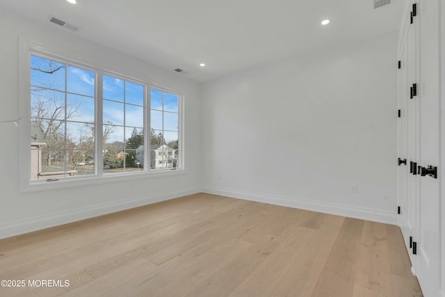 unfurnished room featuring recessed lighting, visible vents, baseboards, and light wood-style floors