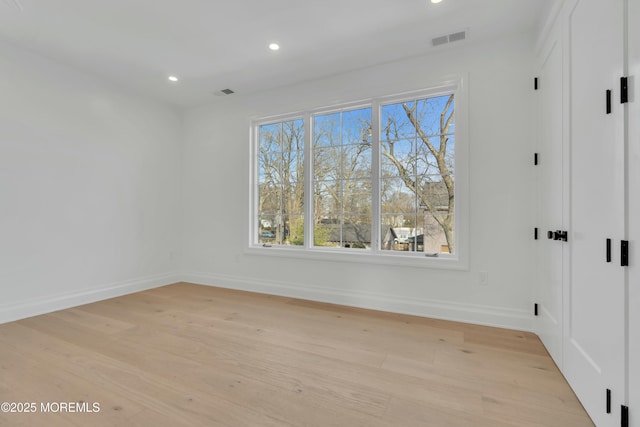 spare room with visible vents, recessed lighting, baseboards, and light wood-style floors