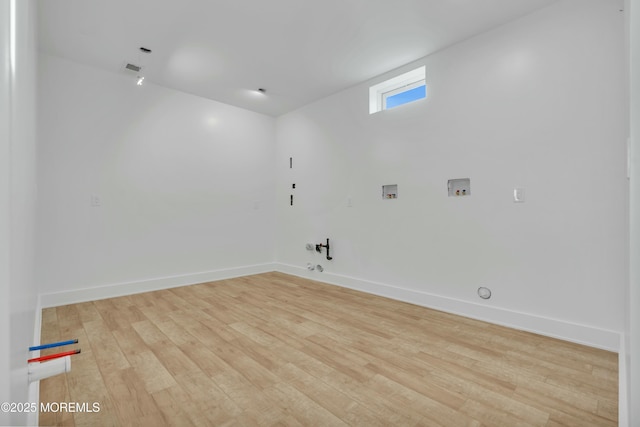 washroom featuring washer hookup, gas dryer hookup, baseboards, and wood finished floors