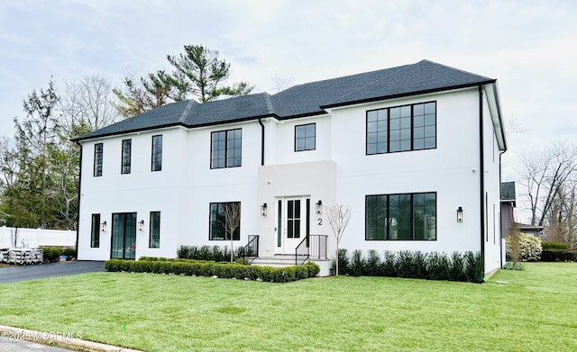 modern farmhouse style home featuring stucco siding and a shingled roof