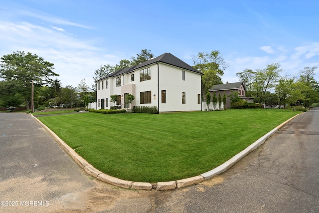 2 Deborah Pl, Oakhurst, NJ 07755 - view of front of house featuring a front yard and stucco siding