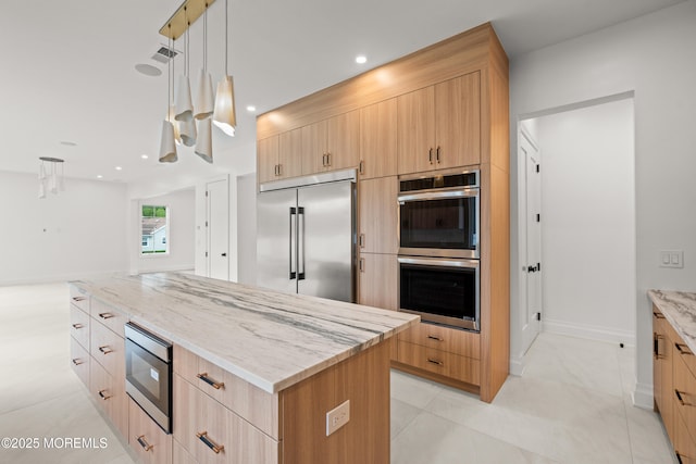 2 Deborah Pl, Oakhurst, NJ 07755 - kitchen with built in appliances, modern cabinets, light stone countertops, light brown cabinets, and decorative light fixtures
