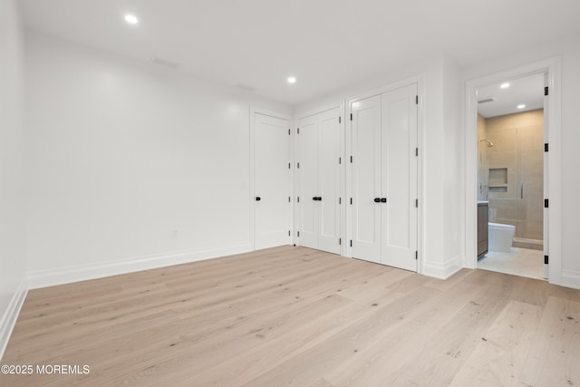 2 Deborah Pl, Oakhurst, NJ 07755 - unfurnished bedroom featuring multiple closets, light wood-style floors, recessed lighting, ensuite bathroom, and baseboards