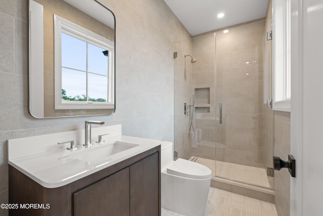 2 Deborah Pl, Oakhurst, NJ 07755 - bathroom featuring vanity, toilet, healthy amount of natural light, tile walls, and a stall shower