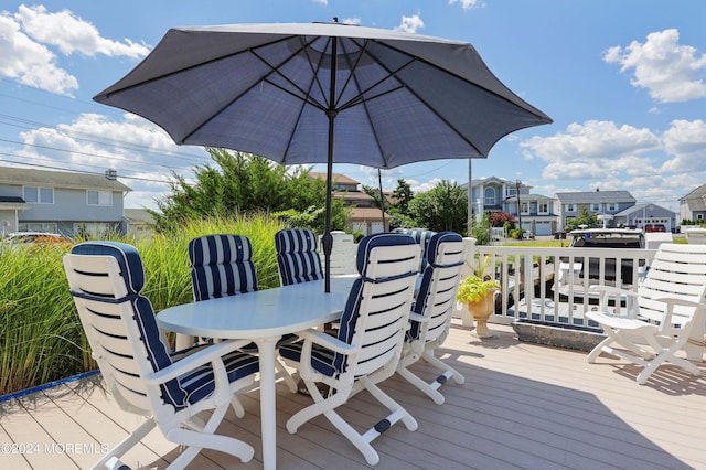 wooden terrace featuring a residential view and outdoor dining area