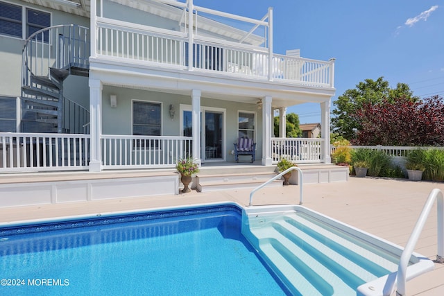 outdoor pool featuring a patio area, stairs, and fence